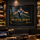 Seattle Reign Jaxon Smith-Njigba framed edition displayed in a dark Seahawks-themed man cave with leather seating.