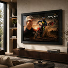 Black framed Jett Lawrence motocross wall art displayed above a timber console in a warm modern living room.
