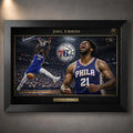 Joel Embiid 76ers NBA wall art shown in a black frame with gold trim and arena action artwork.