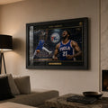 Black framed Joel Embiid 76ers artwork displayed on a living room wall beside a fireplace.