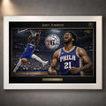 76ers basketball wall art shown in a white frame with black matting on a grey wall.