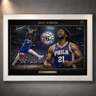 76ers basketball wall art shown in a white frame with black matting on a grey wall.