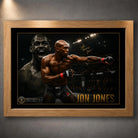 Jon Jones UFC wall art shown in an oak timber frame with black matting and gold detailing on a textured grey wall.