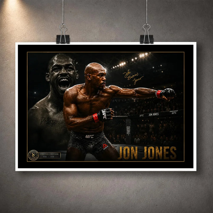 Unframed Jon Jones UFC wall art print with black border and gold detailing displayed with hanging clips on a grey wall.