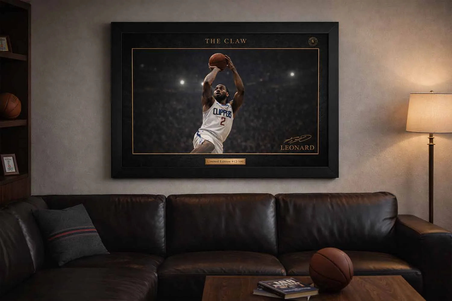 Kawhi Leonard Clippers framed sports art displayed above a leather sofa in a modern man cave.