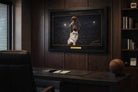 Kawhi Leonard framed sports memorabilia showcased in a luxury office setting with dark wood interior.