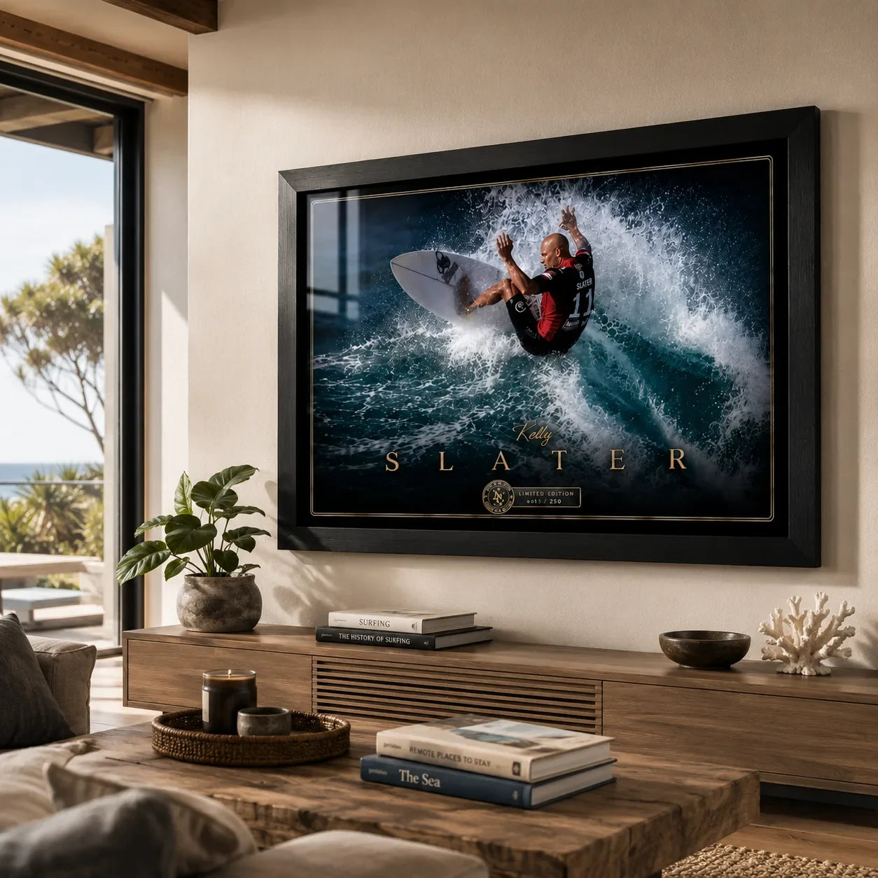 Kelly Slater surfing wall art in a black frame displayed above a timber console in a bright coastal living room.