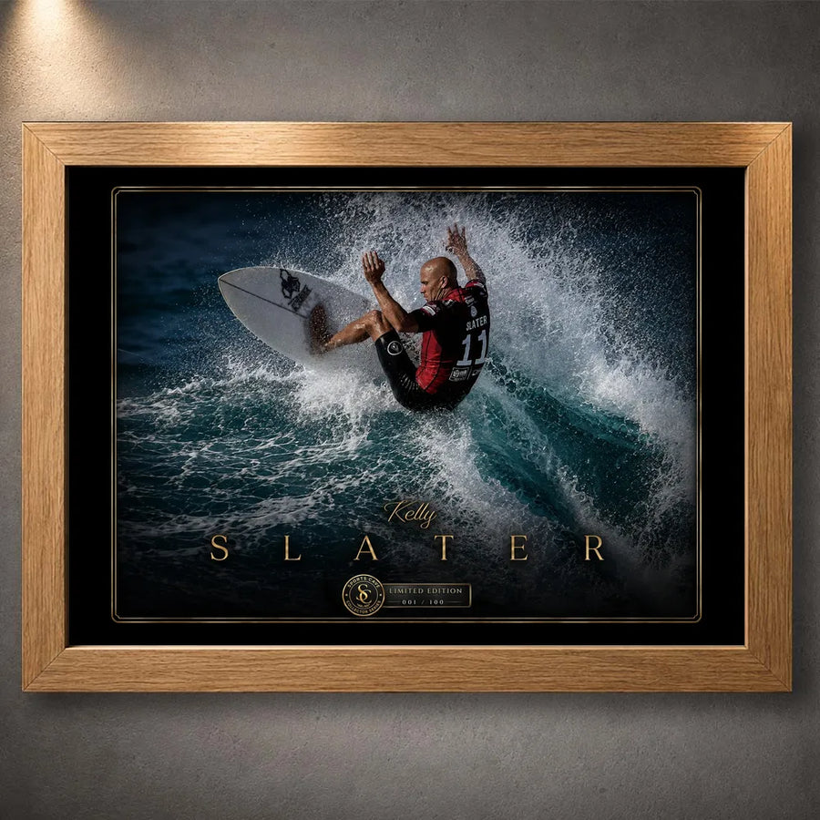 Oak framed Kelly Slater surfing wall art showing his turn through a breaking wave in a black and gold collector design.