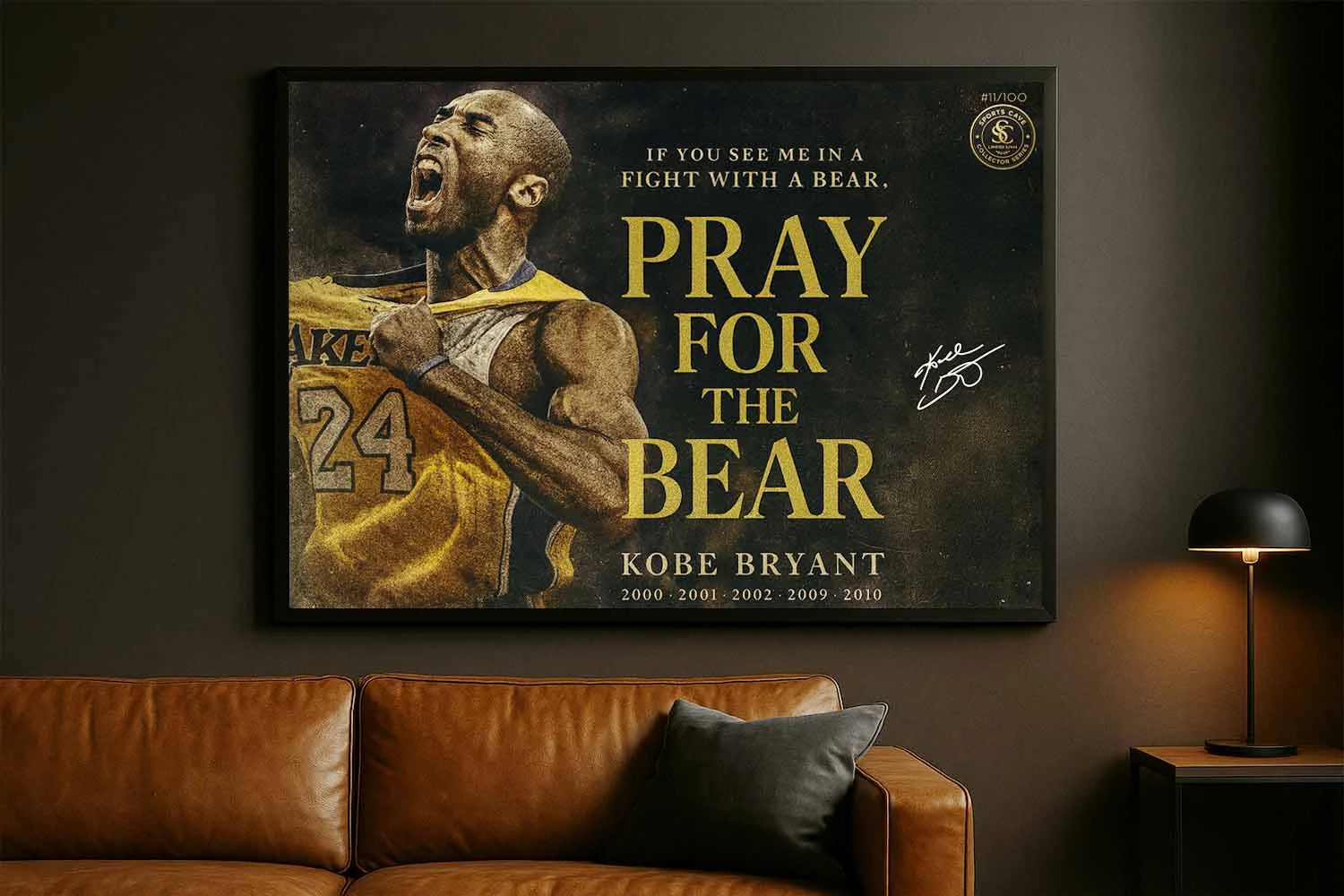 Kobe Bryant Pray For The Bear framed artwork displayed in modern man cave above leather couch.
