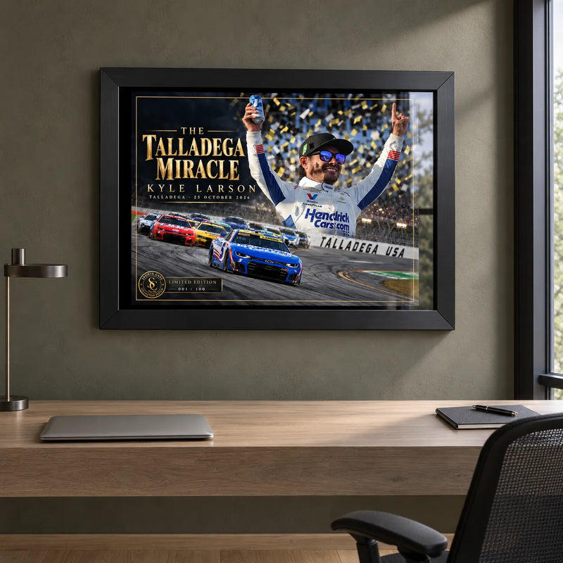 Kyle Larson The Talladega Miracle edition in a black frame above a timber desk in a home office.