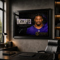 Black framed Lamar Jackson wall art displayed in a dark home office, featuring the Unscripted NFL MVP collector design.