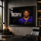 Black framed Lamar Jackson wall art displayed in a dark home office, featuring the Unscripted NFL MVP collector design.
