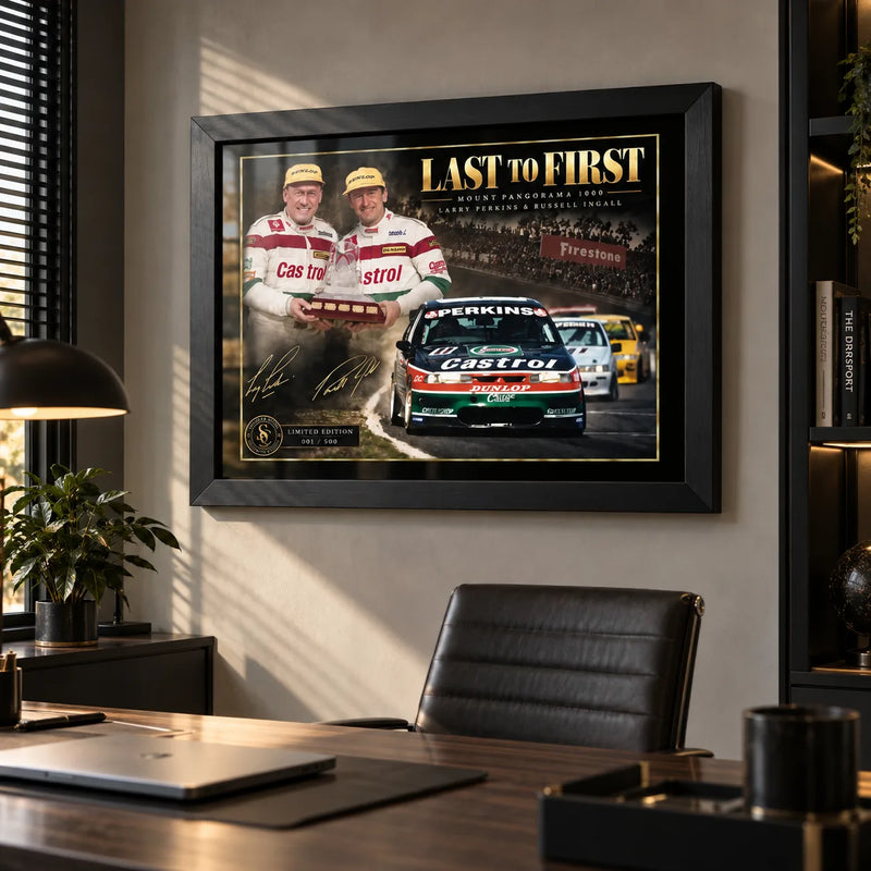 Last to First motorsport wall art displayed in a modern office with a black frame, desk and warm natural light.