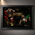 Black framed Latrell Mitchell wall art featuring two action poses in South Sydney colours on a dark red and green design.
