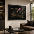 Black-framed Lonhro horse racing wall art displayed in a warm neutral living room above a leather sofa.