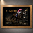 Lonhro horse racing wall art displayed in an oak frame against a textured grey wall with soft overhead lighting.