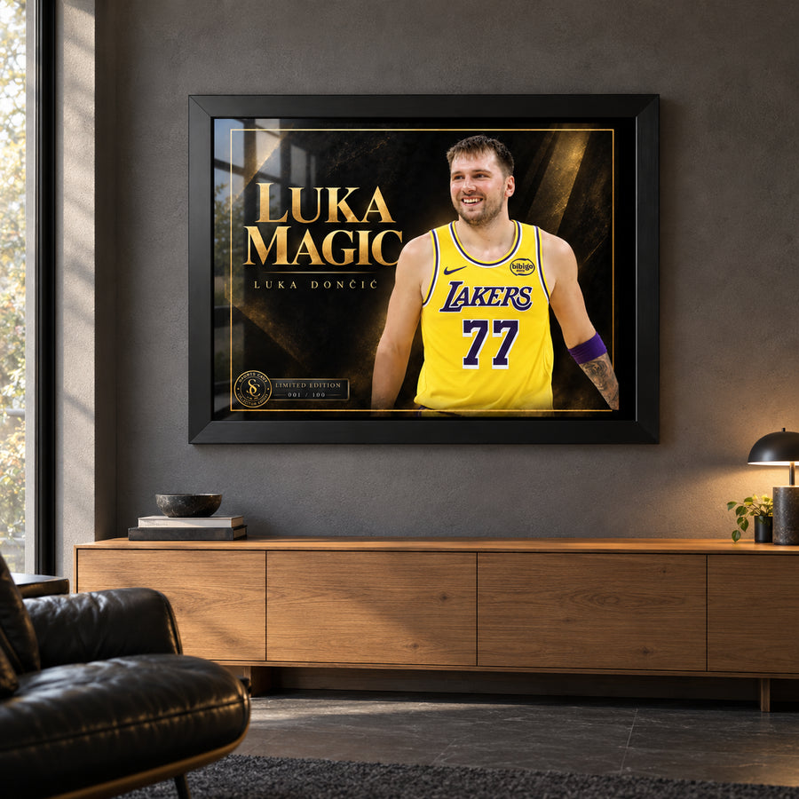 Luka Doncic Luka Magic edition in a black frame above a timber sideboard in a dark man cave with a leather chair.