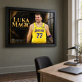 Black-framed Luka Doncic Luka Magic edition on a home office wall beside a window and above a timber desk.