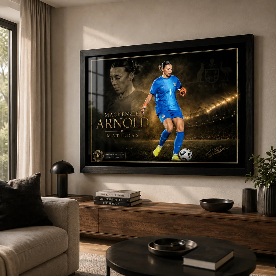 Mackenzie Arnold Matilda's sports wall art in a black frame displayed in a warm modern living room.