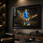 Mackenzie Arnold Matilda's sports wall art in a black frame displayed in a dark premium sports room.