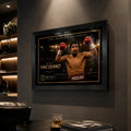 Black framed Manny Pacquiao boxing wall art displayed in a dark premium man cave with leather seating and spot lighting.