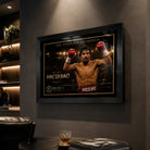 Black framed Manny Pacquiao boxing wall art displayed in a dark premium man cave with leather seating and spot lighting.