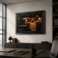 Manny Pacquiao boxing wall art in a black frame above a cabinet in a modern office with a desk and city window.