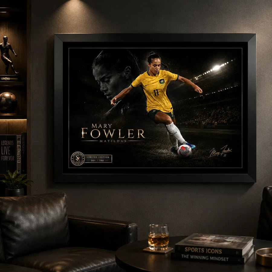 Black framed Mary Fowler wall art displayed in a dark sports-themed man cave with leather seating and warm spot lighting.