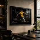 Mary Fowler wall art displayed in a modern home office with a black frame, desk, shelving and natural window light.