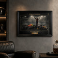 Framed motorsport wall art displayed in a dark fan cave setting.