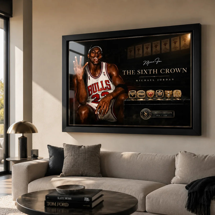 Michael Jordan wall art displayed in a bright contemporary living room above a neutral sofa in a black frame.