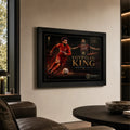 Black framed Mohamed Salah wall art displayed in a premium living room with warm neutral walls and leather seating.