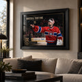 Carey Price wall art displayed above a light sofa in a modern office or lounge with natural window light.