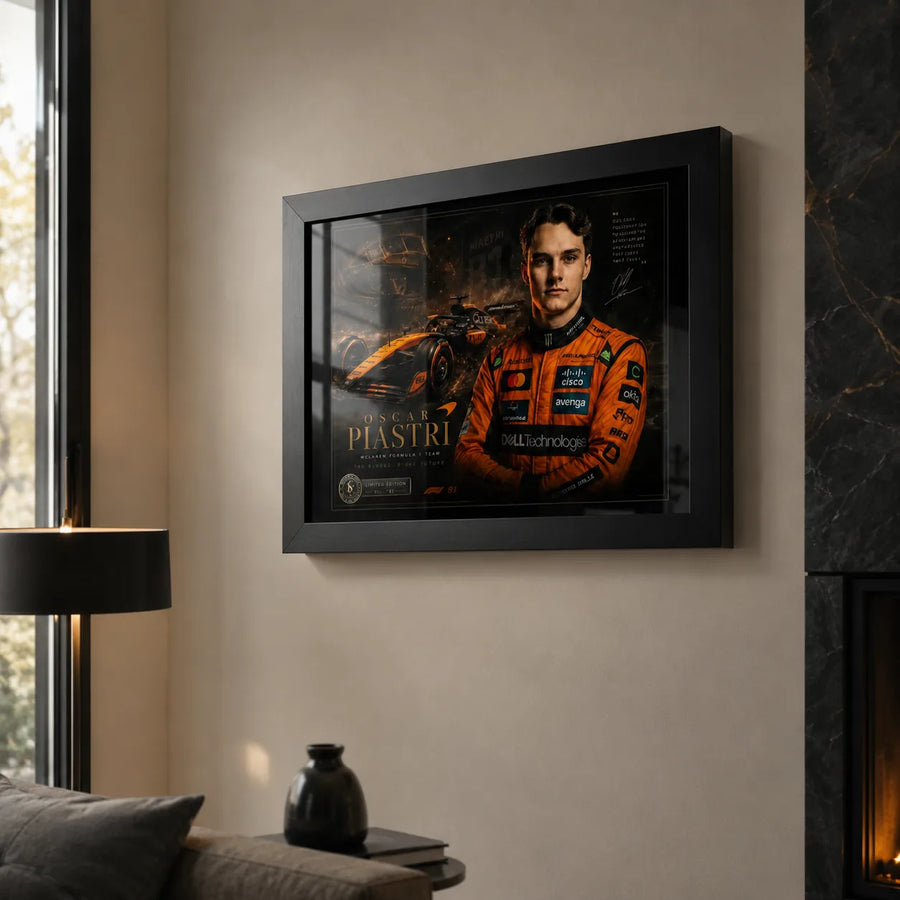 Motorsport wall art in a black frame displayed in a living room beside a fireplace and window.