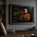 Motorsport wall art in a black frame on a dark man cave wall beside racing memorabilia shelving.
