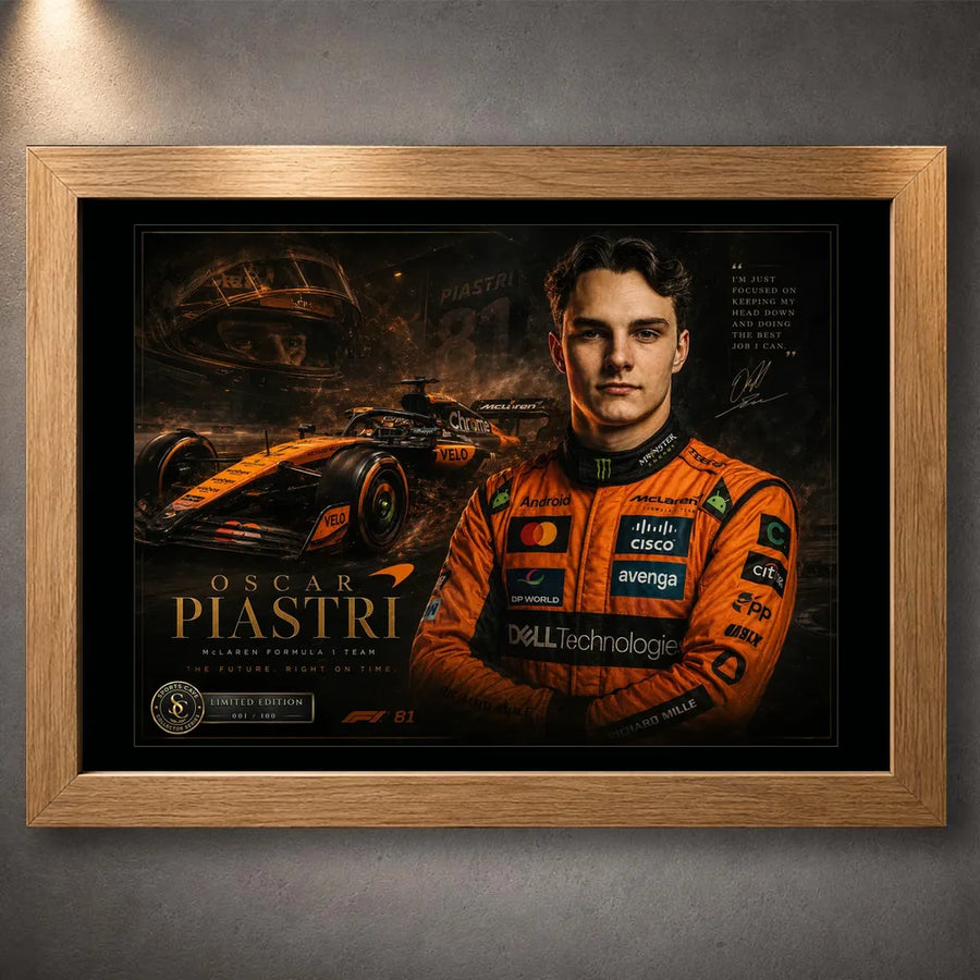 Motorsport wall art in an oak frame, featuring orange racing artwork against a dark wall.