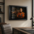 Motorsport wall art in a black frame displayed on a premium office wall above a desk and leather chair.