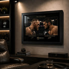 Black framed McGregor vs Khabib wall art styled in a dark man cave with UFC memorabilia and warm shelf lighting.