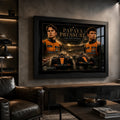 Black framed Piastri vs Norris motorsport wall art displayed in a dark man cave with leather seating.