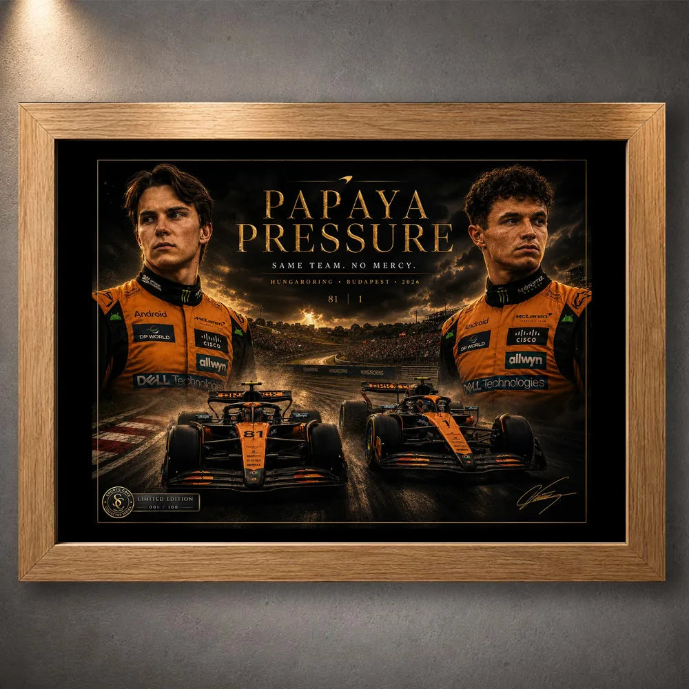 Oak framed Papaya Pressure Piastri vs Norris motorsport wall art shown against a textured grey wall.