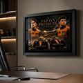 Papaya Pressure McLaren rivalry wall art displayed in a modern office above a timber desk.