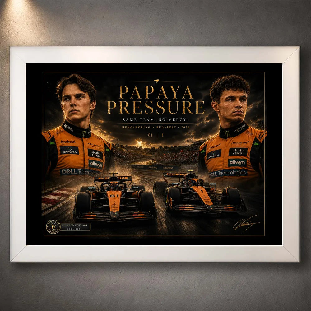 White framed Papaya Pressure Piastri vs Norris wall art shown against a textured grey display wall.