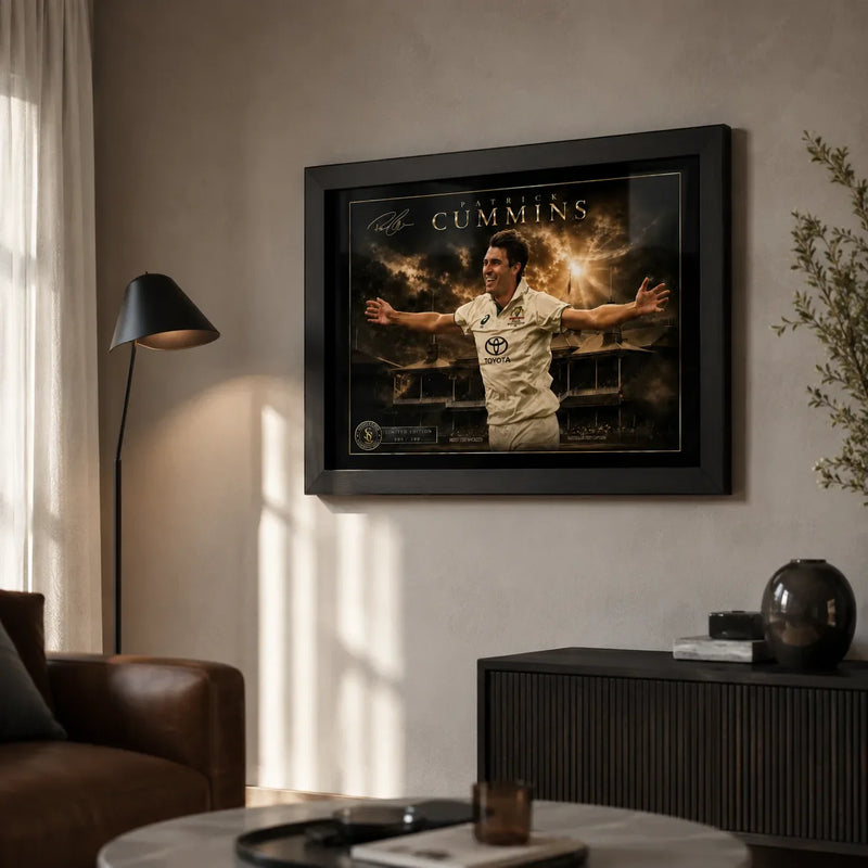 Pat Cummins cricket wall art in a black frame displayed in a warm modern living room with natural window light.
