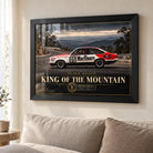 Peter Brock King of the Mountain wall art in a bright living room, displayed in a black frame above a neutral sofa.