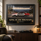 Peter Brock King of the Mountain wall art in a collector lounge above a record player, with a black frame and window reflections.