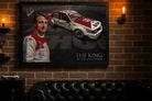 Peter Brock King of the Mountain framed print on brick man cave wall above leather sofa.