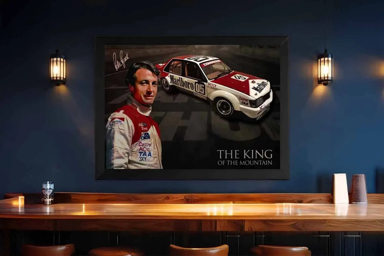 Peter Brock King of the Mountain VK Commodore black framed wall art above bar counter.