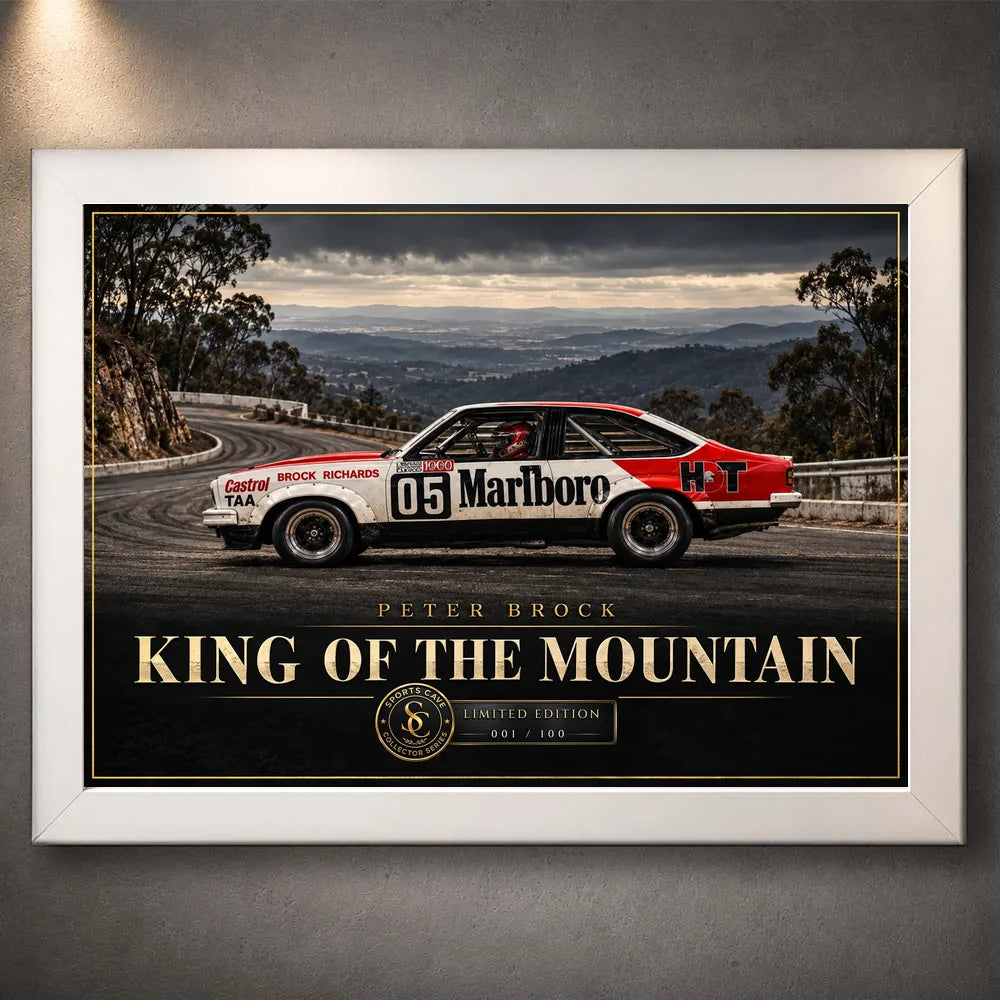 Peter Brock King of the Mountain wall art in a white frame, with gold title lettering and a red and white racing car.