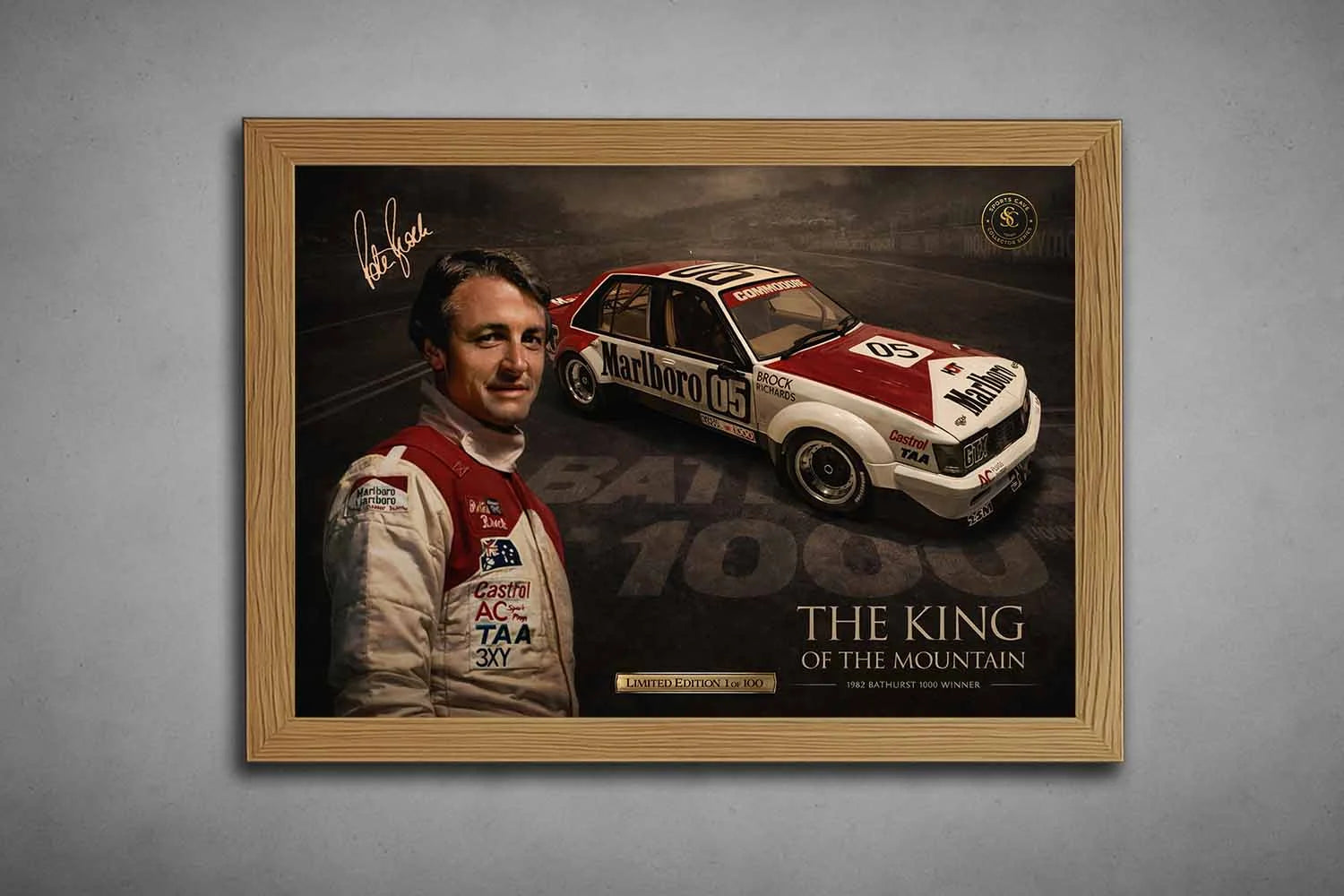 Oak-framed Peter Brock Bathurst 1000 Holden Commodore wall print, framed sports memorabilia on concrete backdrop.