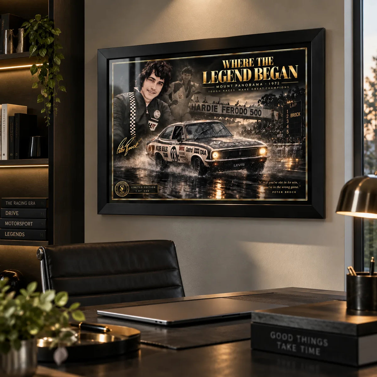Peter Brock wall art displayed above a desk in a modern office, styled in a black frame for a motorsport collector space.